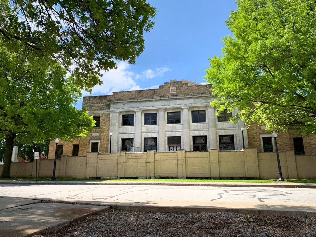 Front of Joplin Memorial Hall framed by trees, with its broad accessible approach visible.